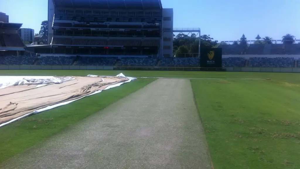 Cricket ground with empty stands and green outfield