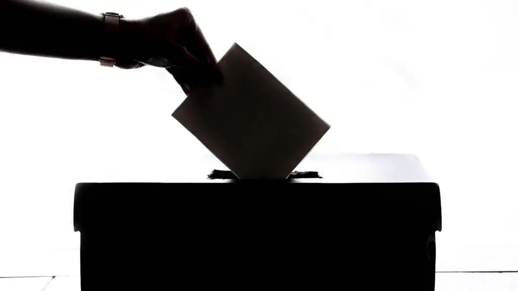 Hand placing a ballot paper into a ballot box