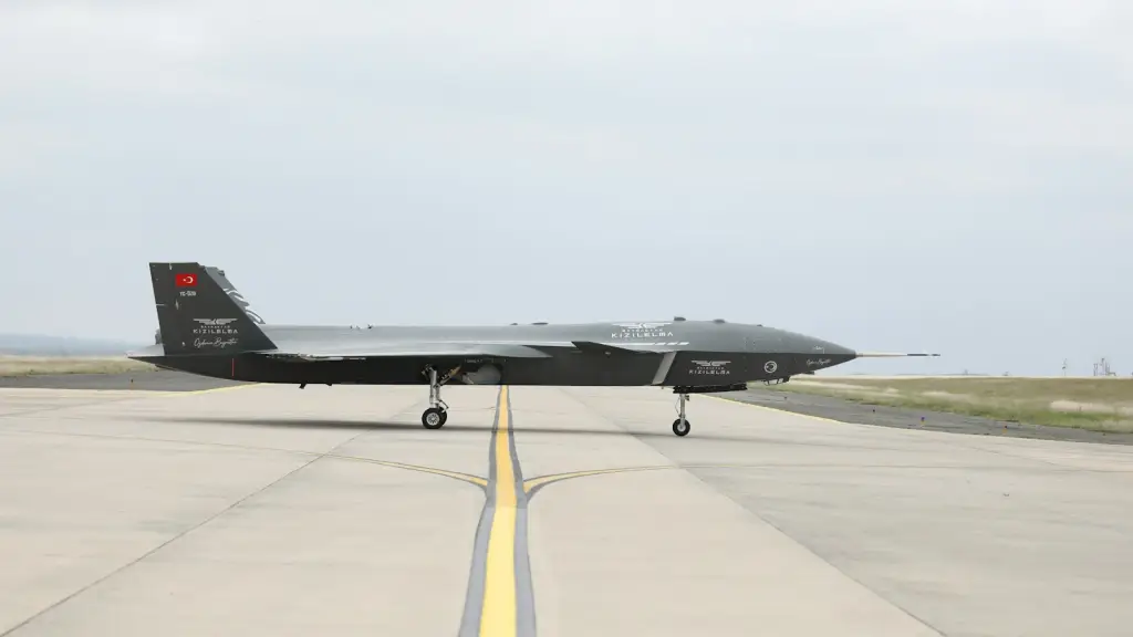 Dark-coloured military drone on an open runway