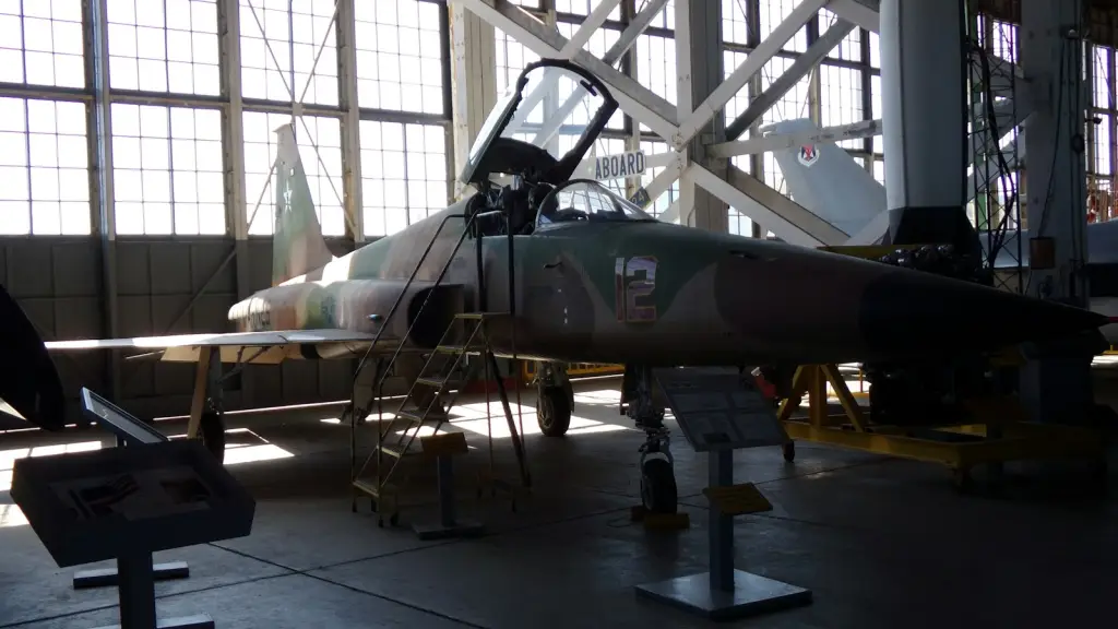 Military jet aircraft displayed inside a large hangar