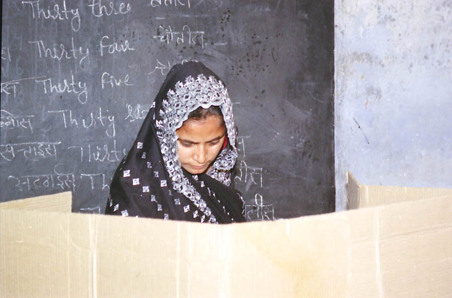 Voter casting ballot at a Delhi polling booth