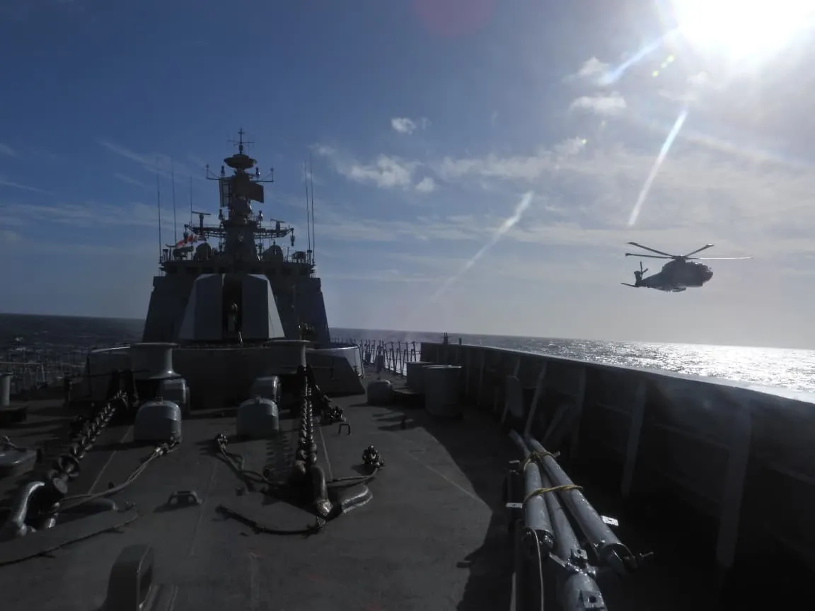 View from a ship's deck with a helicopter overhead during the sea phase of KONKAN-26
