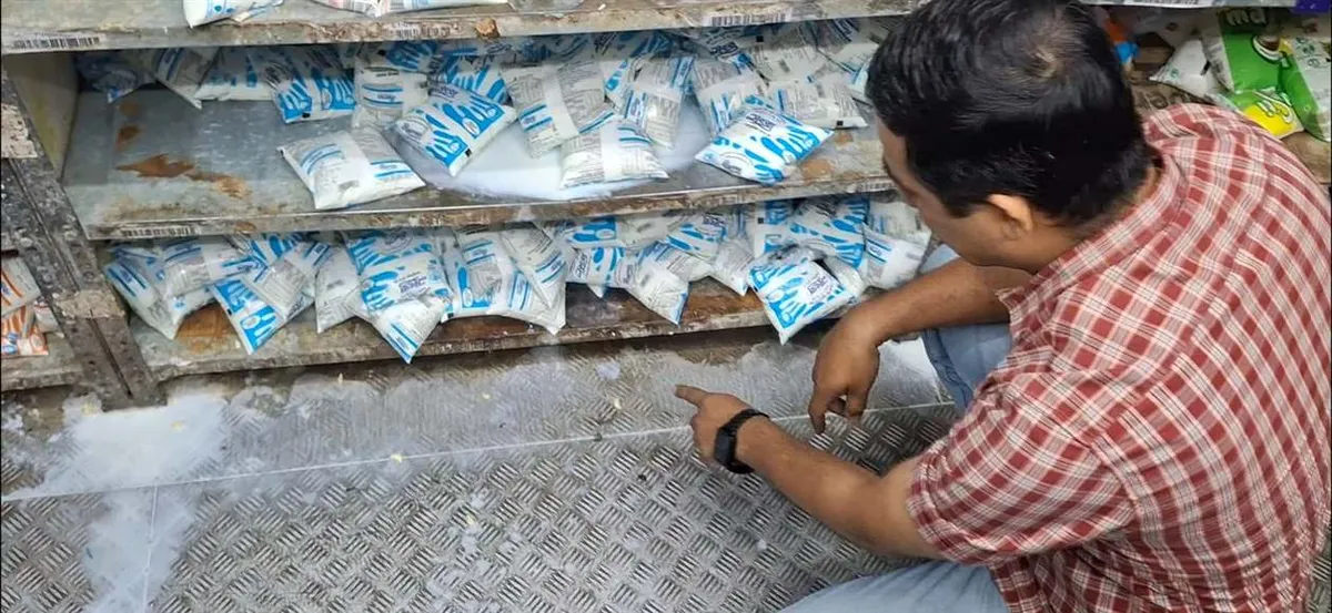 An officer inspects packed goods at a store