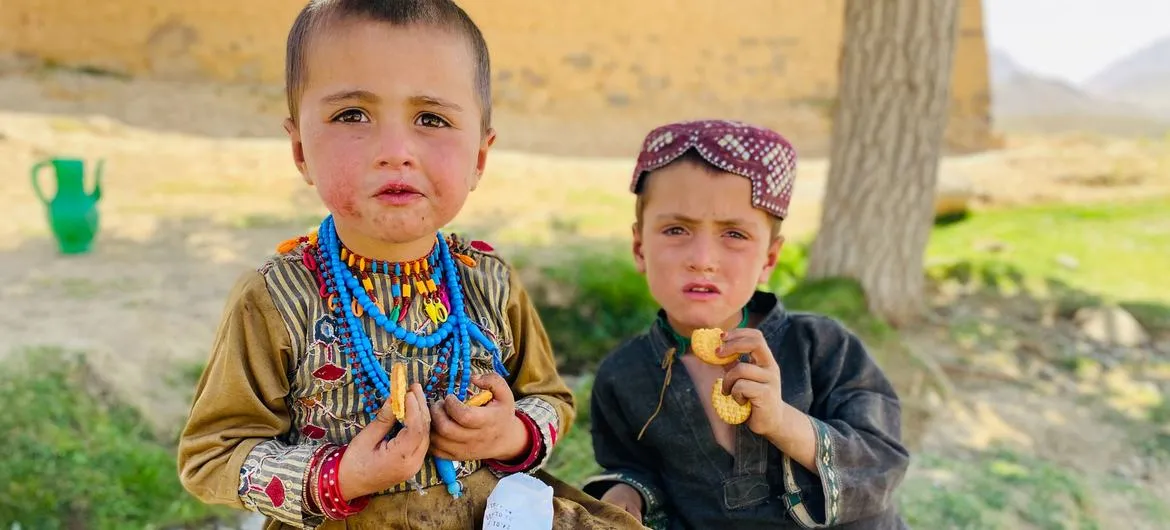 Afghanistan hunger: Two children in Afghanistan eat nutritional biscuits