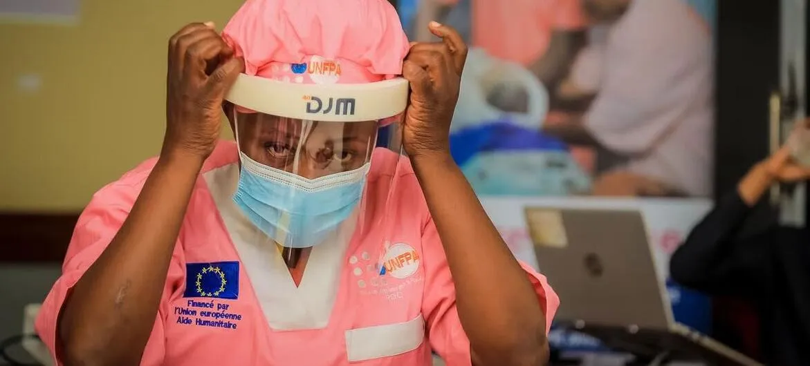 Ebola readiness: A nurse puts on protective gear before treating patients in eastern DR Congo (file photo)