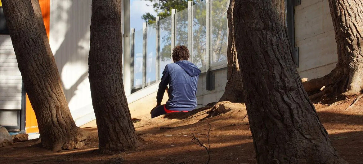 West African migrants: A child prays alone at a migrant reception centre in Lampedusa, Italy